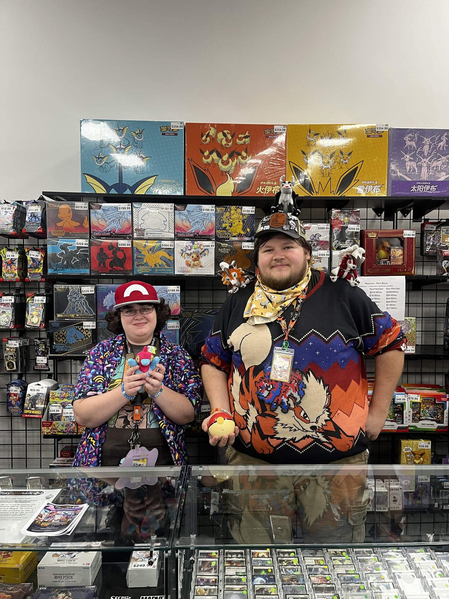 Two Play and Talk team members at the Pokemon trading card counter
