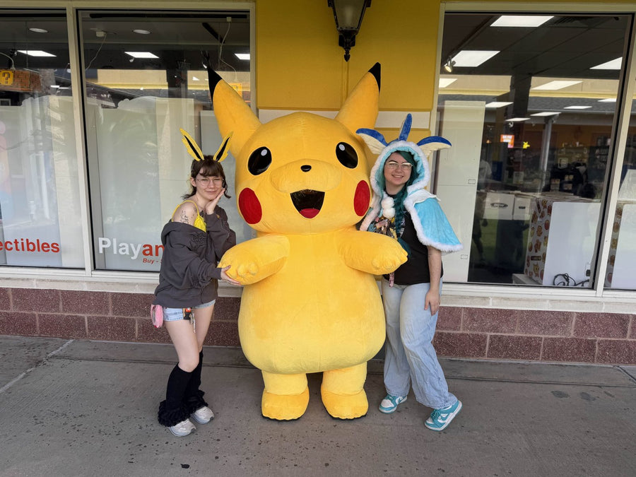 Play and Talk team members with the Pikachu mascot at a store event